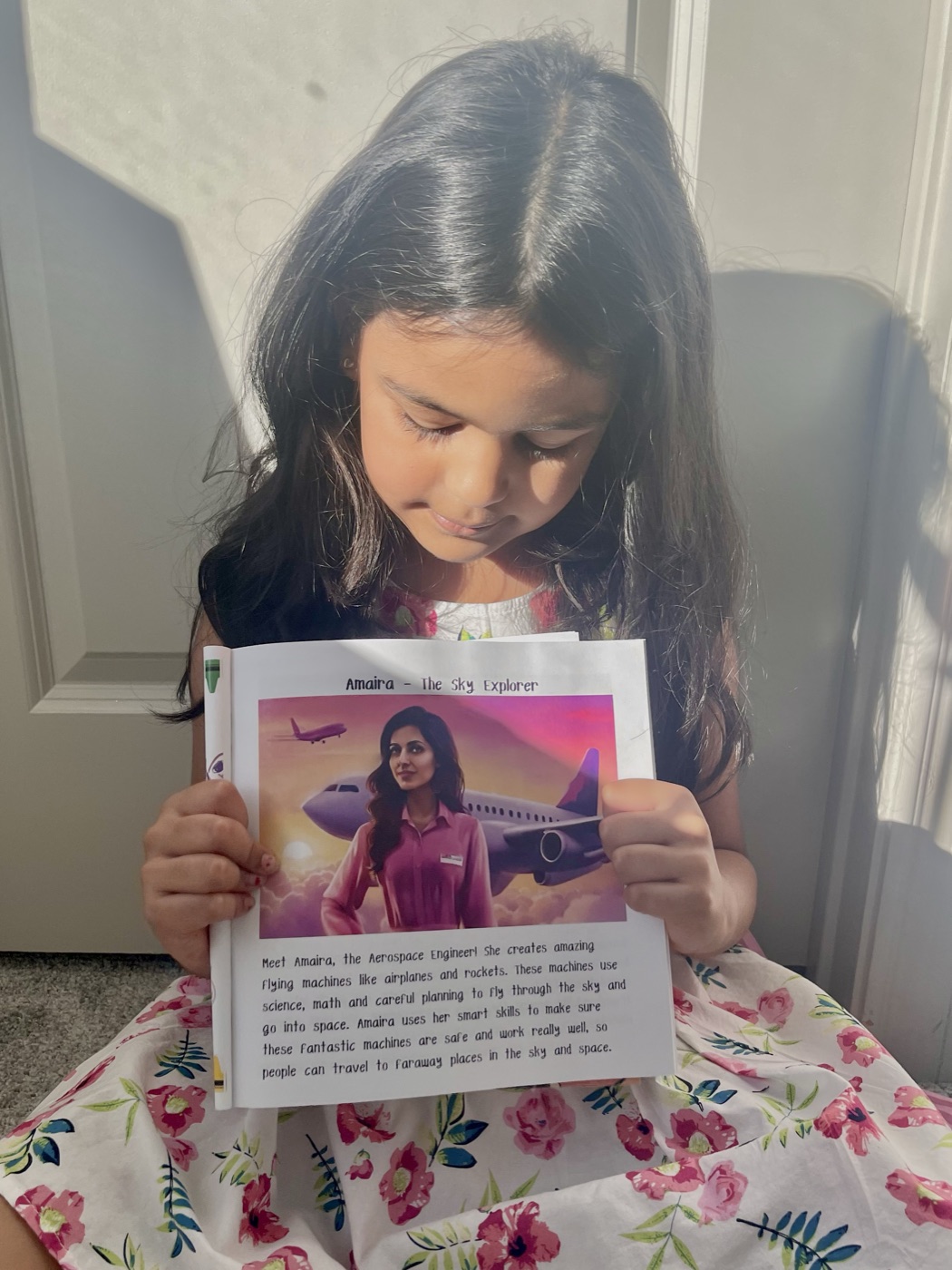 Amaira proudly showing the character named after her in Girls Can Be Engineers Too